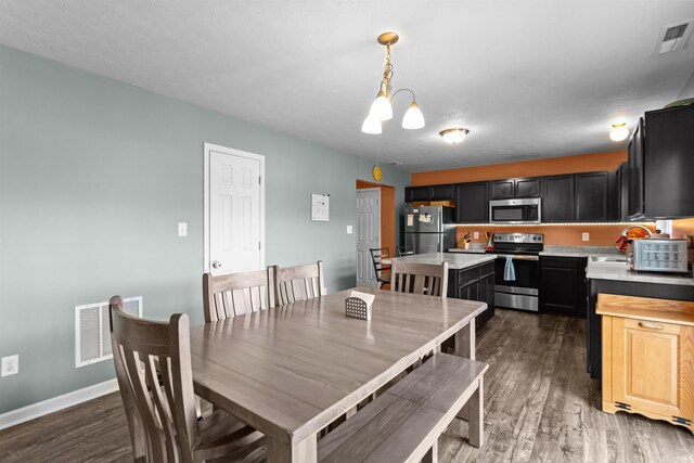 384 Ariel Dr, Kokomo, IN 46901 - dining area with a chandelier, dark wood-style floors, and baseboards