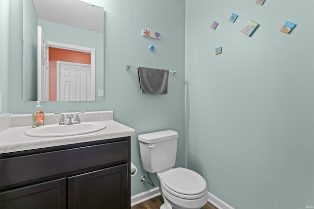 384 Ariel Dr, Kokomo, IN 46901 - half bathroom with toilet, wood finished floors, vanity, and baseboards