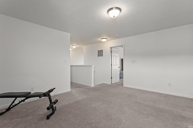 384 Ariel Dr, Kokomo, IN 46901 - workout room featuring carpet floors, baseboards, and a textured ceiling