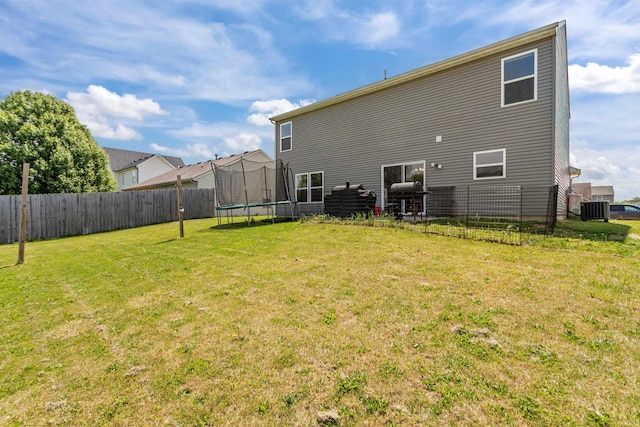 384 Ariel Dr, Kokomo, IN 46901 - rear view of property with a trampoline and central air condition unit