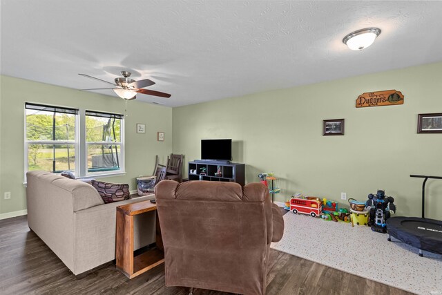 384 Ariel Dr, Kokomo, IN 46901 - living room featuring a ceiling fan, dark wood-type flooring, and baseboards
