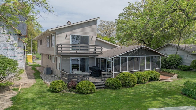 5002 E Oriole Dr, Monticello, IN 47960 - back of house with a chimney, cooling unit, a sunroom, a lawn, and a balcony