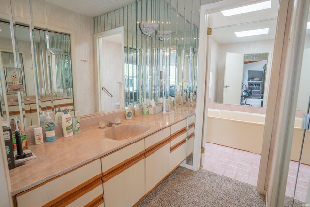 5002 E Oriole Dr, Monticello, IN 47960 - full bathroom with a skylight, vanity, and a tub