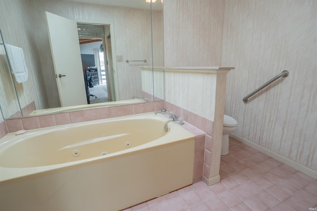5002 E Oriole Dr, Monticello, IN 47960 - full bath with wallpapered walls, baseboards, a tub with jets, toilet, and tile patterned floors