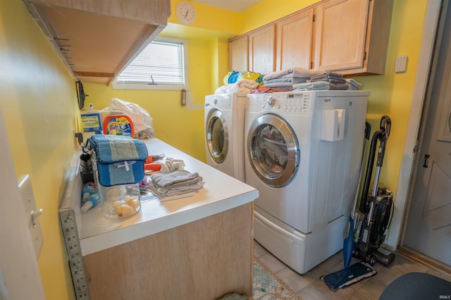 5002 E Oriole Dr, Monticello, IN 47960 - clothes washing area featuring washer and dryer, cabinet space, and light tile patterned floors