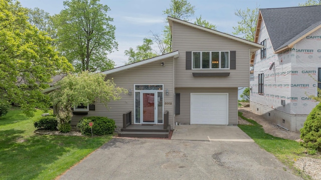 5002 E Oriole Dr, Monticello, IN 47960 - mid-century home featuring driveway, an attached garage, and a front lawn