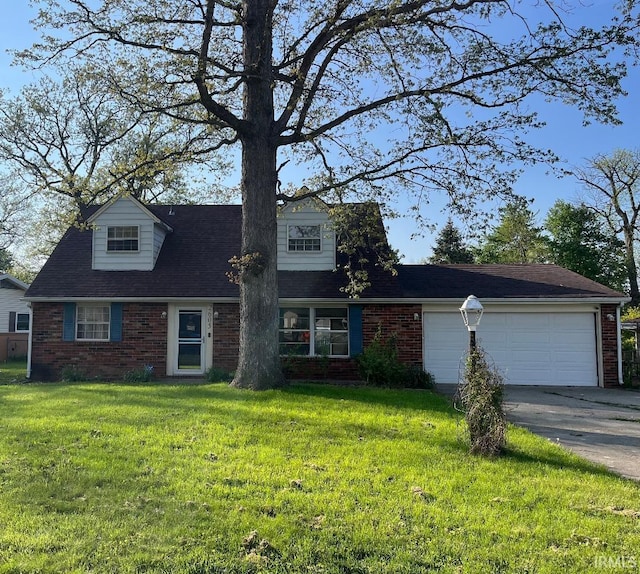view of front of property with brick siding, a front yard, a garage, and asphalt driveway