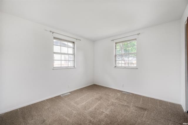 spare room with carpet floors and baseboards