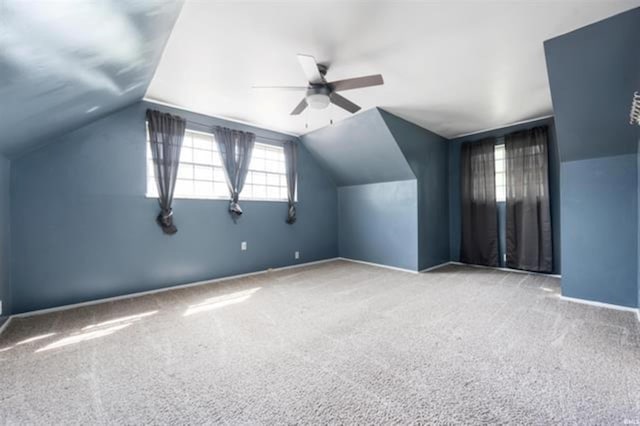 additional living space with carpet, vaulted ceiling, ceiling fan, and baseboards