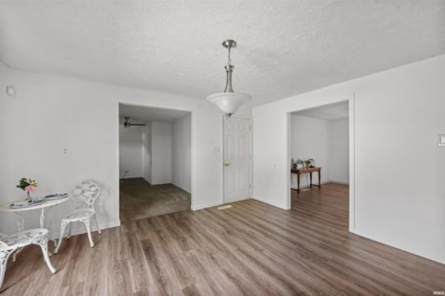 dining room featuring wood finished floors and a textured ceiling
