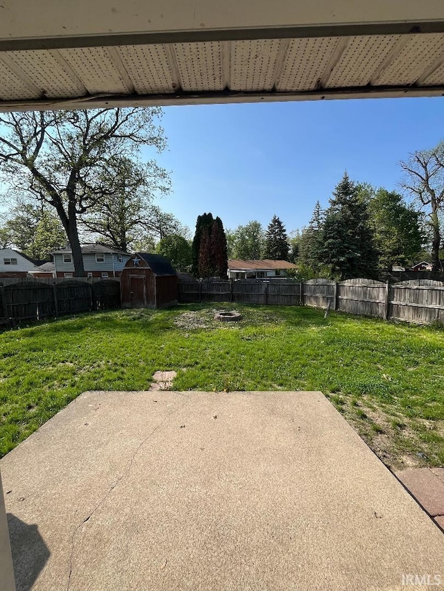 view of patio / terrace with a shed and an outbuilding