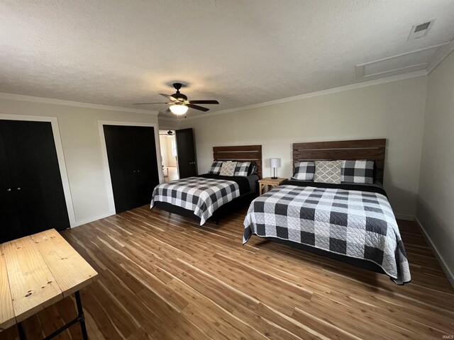 18065 Buzzard Roost Rd, Magnet, IN 47520 - bedroom featuring wood finished floors, baseboards, a textured ceiling, ceiling fan, and crown molding