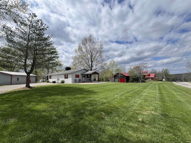 18065 Buzzard Roost Rd, Magnet, IN 47520 - view of green lawn with an outbuilding