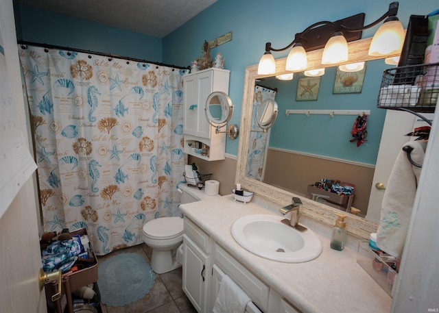 bathroom featuring toilet, tile patterned flooring, vanity, and a shower with curtain