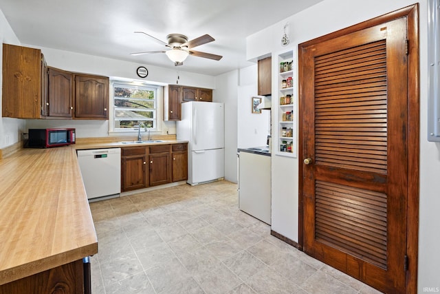 kitchen featuring white appliances, a sink, ceiling fan, light countertops, and dark brown cabinetry
