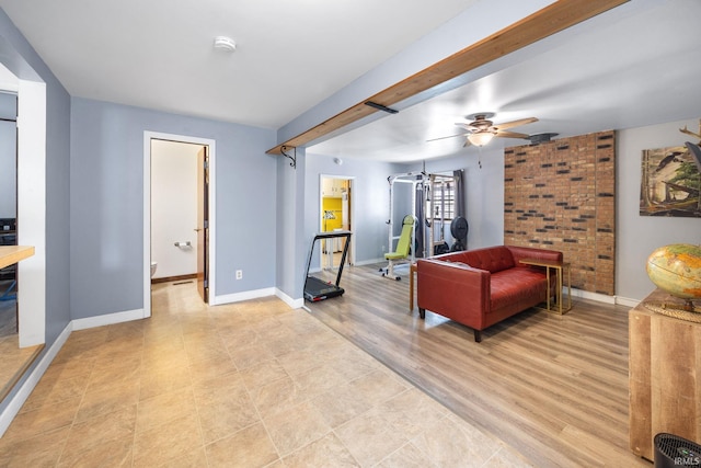 sitting room with baseboards and a ceiling fan