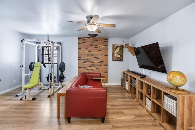 workout room featuring a ceiling fan, wood finished floors, and baseboards
