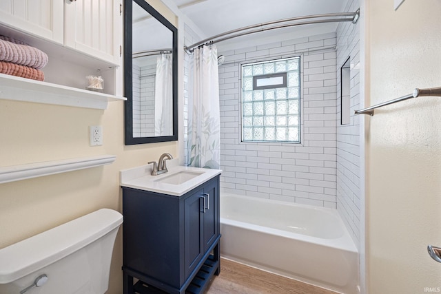 full bathroom with toilet, wood finished floors, vanity, and shower / bath combination with curtain