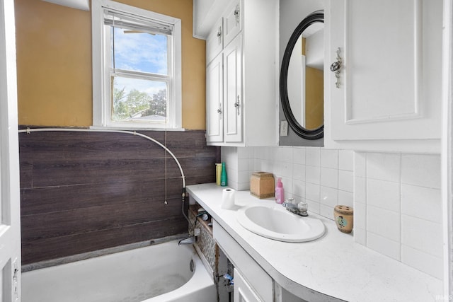 full bathroom with tasteful backsplash and vanity