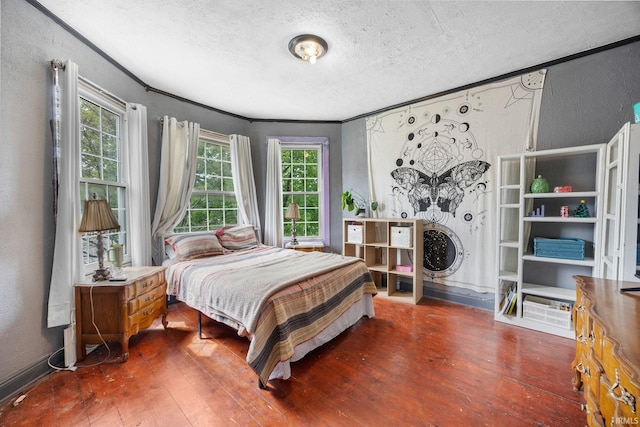 bedroom featuring a textured wall, a textured ceiling, and wood-type flooring