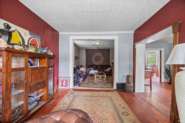 hallway with hardwood / wood-style flooring and a textured ceiling