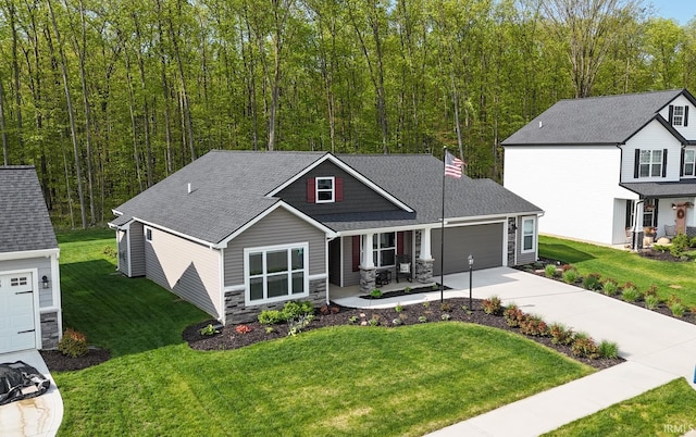 13865 Escondida Cv, Fort Wayne, IN 46845 - view of front of house featuring concrete driveway, stone siding, a porch, an attached garage, and a front yard