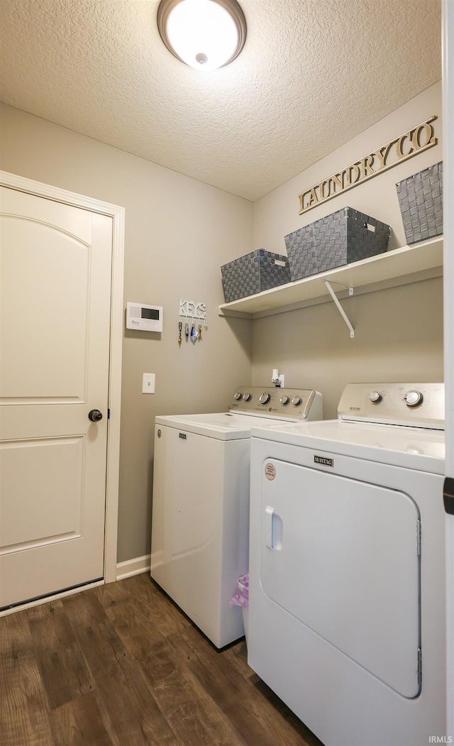 13865 Escondida Cv, Fort Wayne, IN 46845 - laundry area featuring washing machine and dryer, dark wood-type flooring, and a textured ceiling