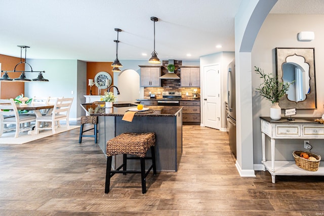 13865 Escondida Cv, Fort Wayne, IN 46845 - kitchen featuring appliances with stainless steel finishes, wall chimney exhaust hood, a sink, a kitchen bar, and backsplash