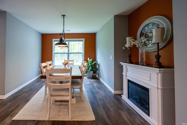 13865 Escondida Cv, Fort Wayne, IN 46845 - dining room with dark wood-style flooring, baseboards, and a glass covered fireplace