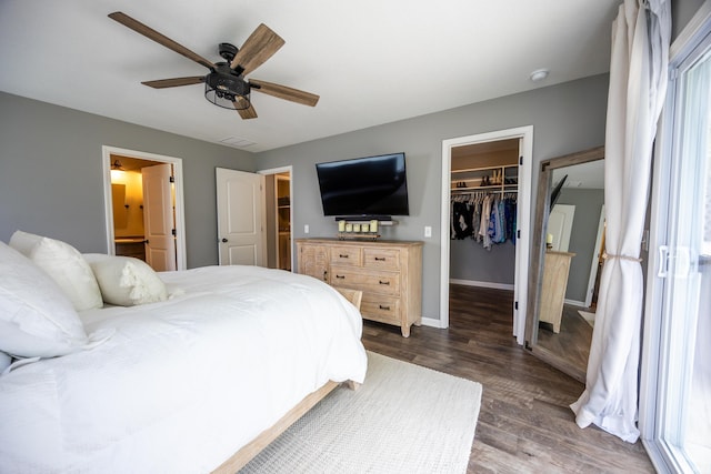 13865 Escondida Cv, Fort Wayne, IN 46845 - bedroom with wood finished floors, a walk in closet, a closet, ceiling fan, and baseboards