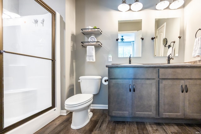 13865 Escondida Cv, Fort Wayne, IN 46845 - bathroom with toilet, a stall shower, wood finished floors, baseboards, and double vanity