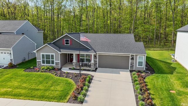 13865 Escondida Cv, Fort Wayne, IN 46845 - craftsman house with stone siding, an attached garage, concrete driveway, a porch, and a front lawn