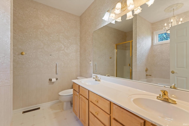 3821 Emerald Bay St, Mishawaka, IN 46545 - bathroom with a shower stall, toilet, double vanity, a bathtub, and wainscoting