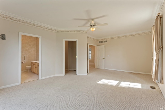 3821 Emerald Bay St, Mishawaka, IN 46545 - unfurnished bedroom featuring light carpet, connected bathroom, crown molding, a walk in closet, and a closet