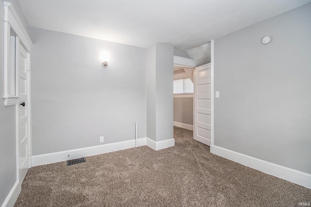 spare room with carpet, baseboards, and a smoke detector