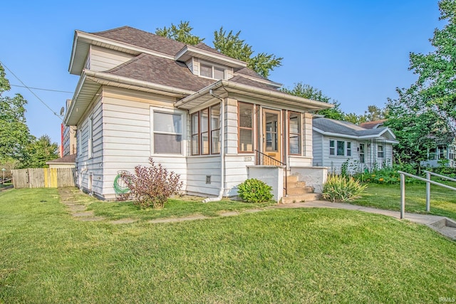view of front of property with a sunroom and roof with shingles