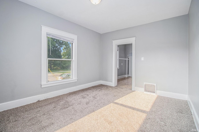 carpeted spare room with baseboards