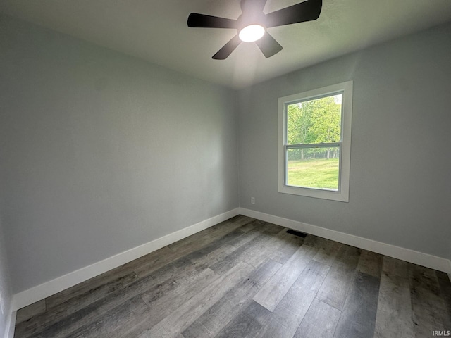916 2nd Ave, Jasper, IN 47546 - spare room with baseboards, dark wood-style flooring, and a ceiling fan