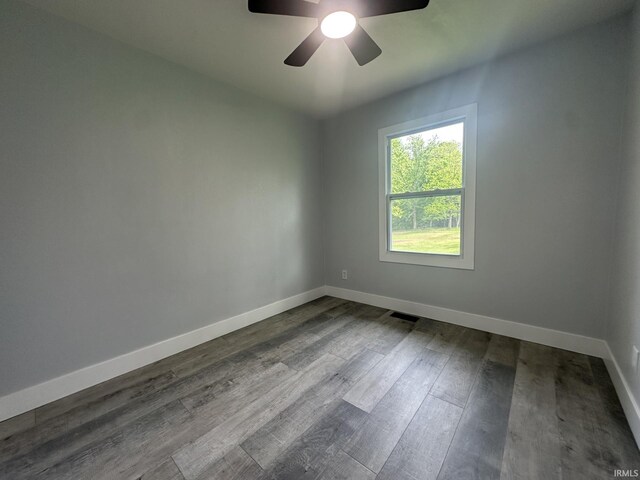 916 2nd Ave, Jasper, IN 47546 - unfurnished room with baseboards, a ceiling fan, and dark wood-style flooring
