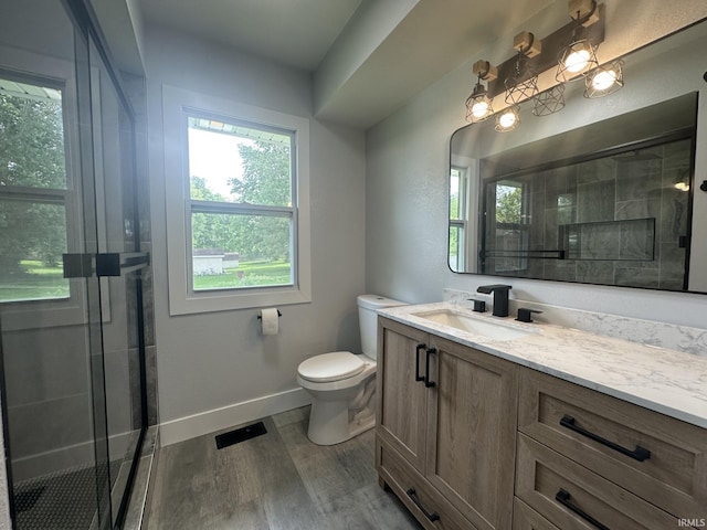 916 2nd Ave, Jasper, IN 47546 - bathroom featuring a shower stall, wood finished floors, toilet, baseboards, and vanity