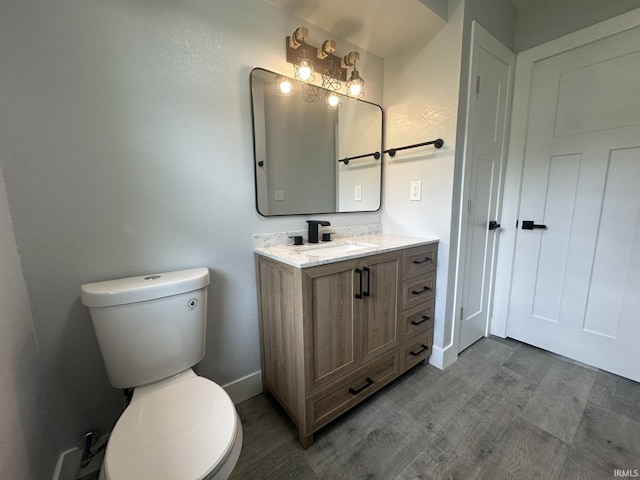916 2nd Ave, Jasper, IN 47546 - half bath with toilet, vanity, baseboards, and wood finished floors