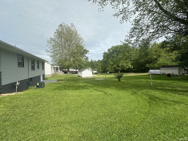 916 2nd Ave, Jasper, IN 47546 - view of green lawn with central AC, a shed, and an outbuilding