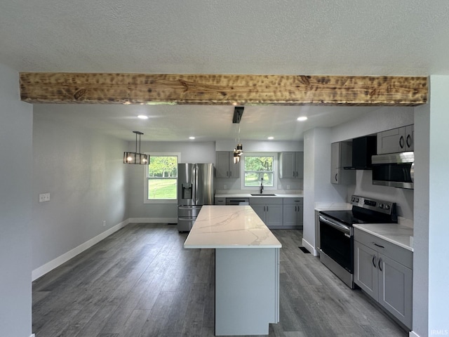 916 2nd Ave, Jasper, IN 47546 - kitchen with appliances with stainless steel finishes, gray cabinetry, a sink, a center island, and dark wood-style flooring