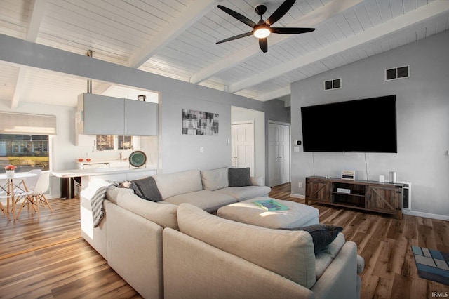 living room featuring a ceiling fan, light wood-style flooring, and baseboards