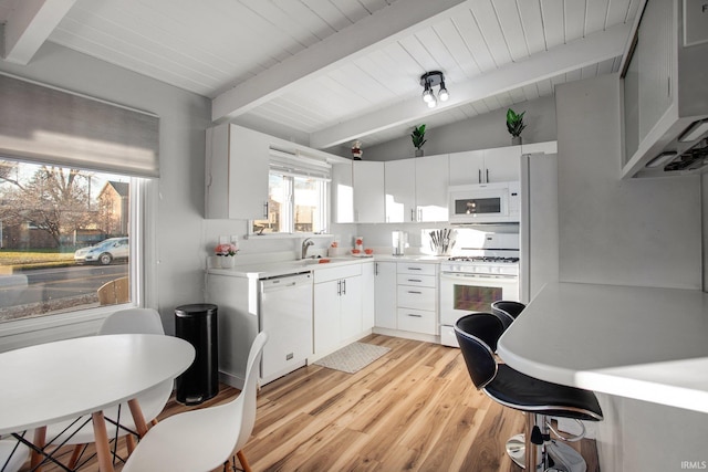 kitchen featuring white appliances, light wood-style floors, light countertops, white cabinetry, and wood ceiling