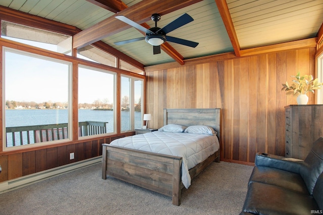 carpeted bedroom with a water view, wood walls, a baseboard radiator, wooden ceiling, and a ceiling fan