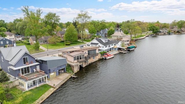 aerial view of residential area featuring a large body of water