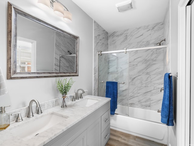 541 S Kelsey Ave, Evansville, IN 47714 - full bathroom featuring bath / shower combo with glass door, double vanity, and wood finished floors