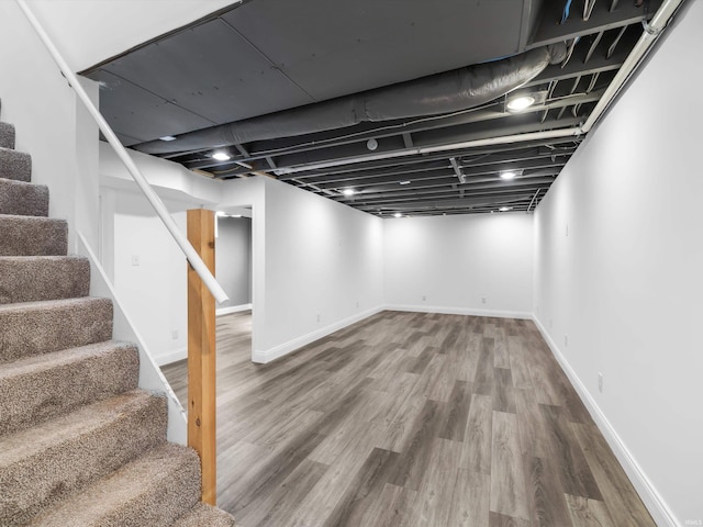 541 S Kelsey Ave, Evansville, IN 47714 - finished basement featuring stairway, wood finished floors, and baseboards