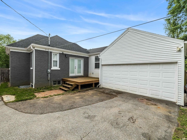 541 S Kelsey Ave, Evansville, IN 47714 - view of home's exterior with french doors, brick siding, a shingled roof, driveway, and a garage